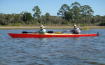 A couple paddling a red-hulled Chesapeake Triple wooden kayak built by David M. Thumbnail