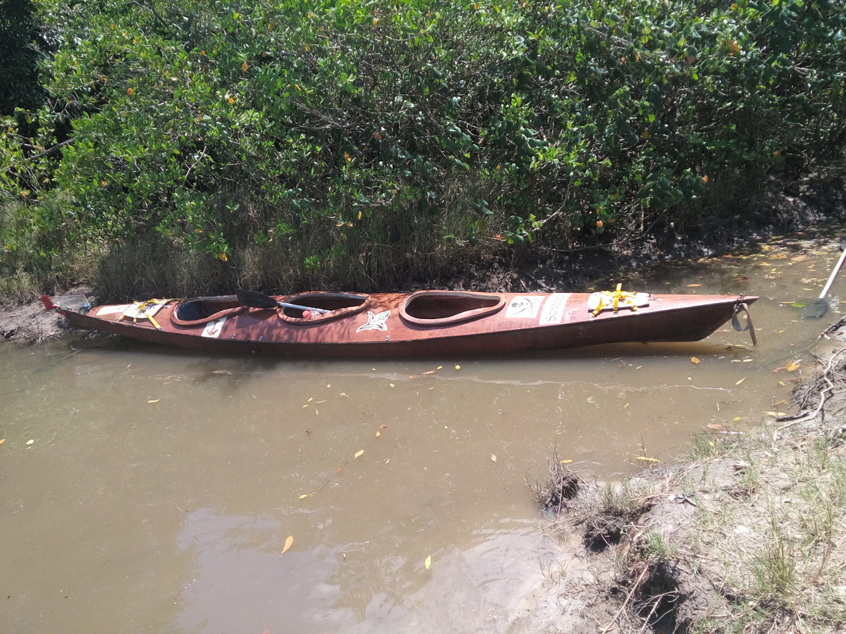 A Chesapeake Triple wooden kayak built by Jocedir S. on the shore in the Sao Paulo Nature Preserve in Brazil