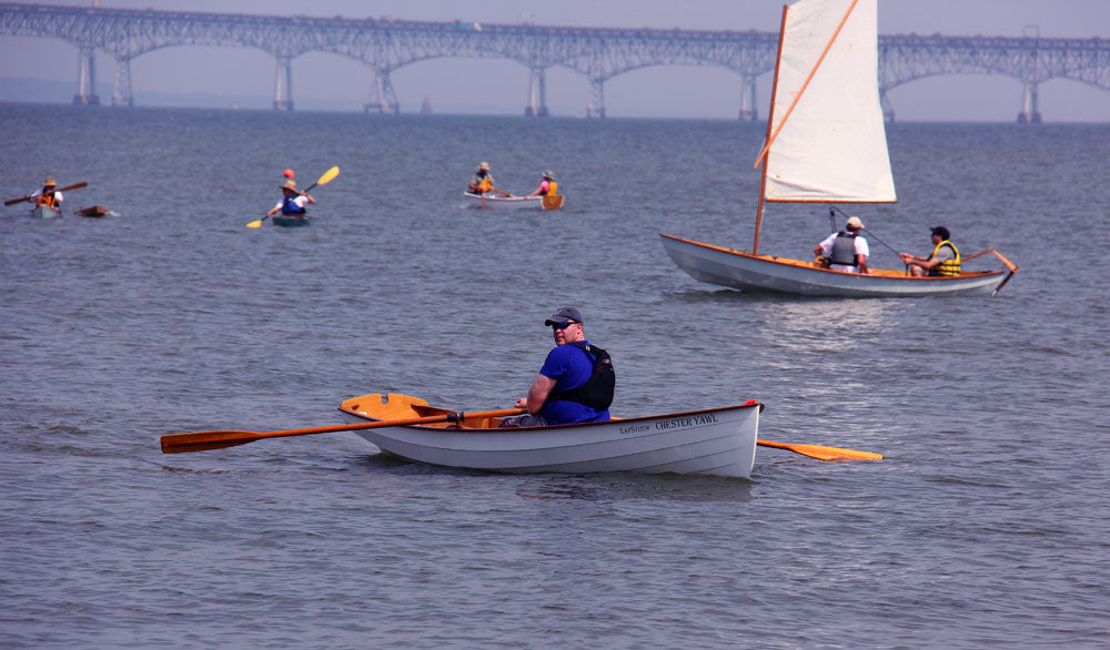 A collection of boats, including the Chester Yawl, at a CLC event near Annapolis, Maryland