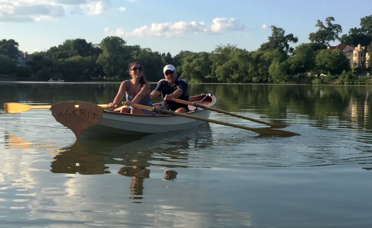 A couple enjoying a tandem row in UGKRIT, a Chester Yawl.
