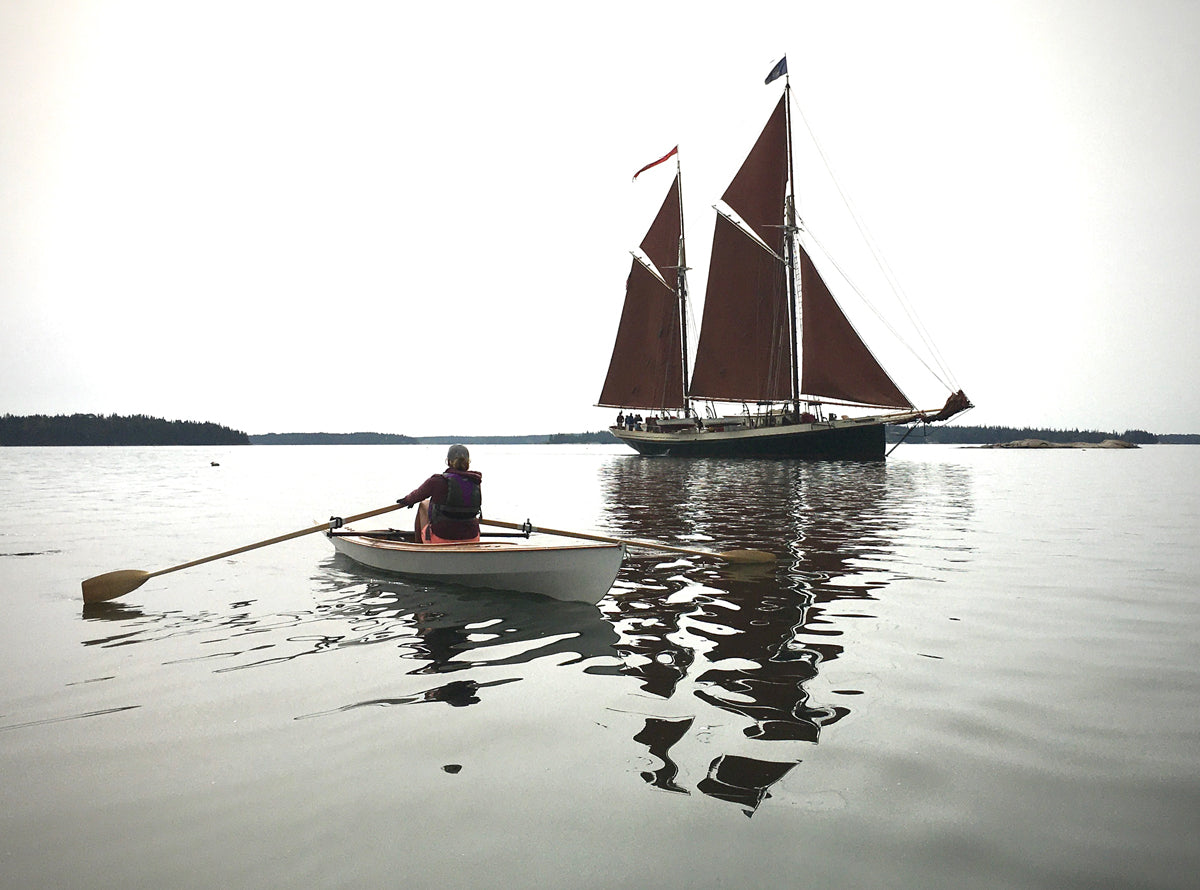 The schooner ANGELIQUE comes to rest as Christine Y. rows by in her Expedition Wherry.
