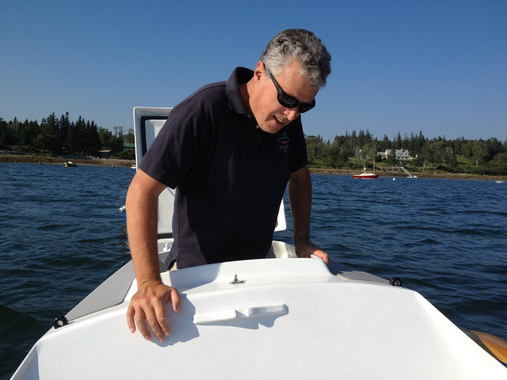 Matt Murphy of WoodenBoat Magazine emerges from the hatch of the Faering Cruiser.