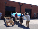 Crew at CLC moving the Faering Cruiser from shop to trailer.  Thumbnail