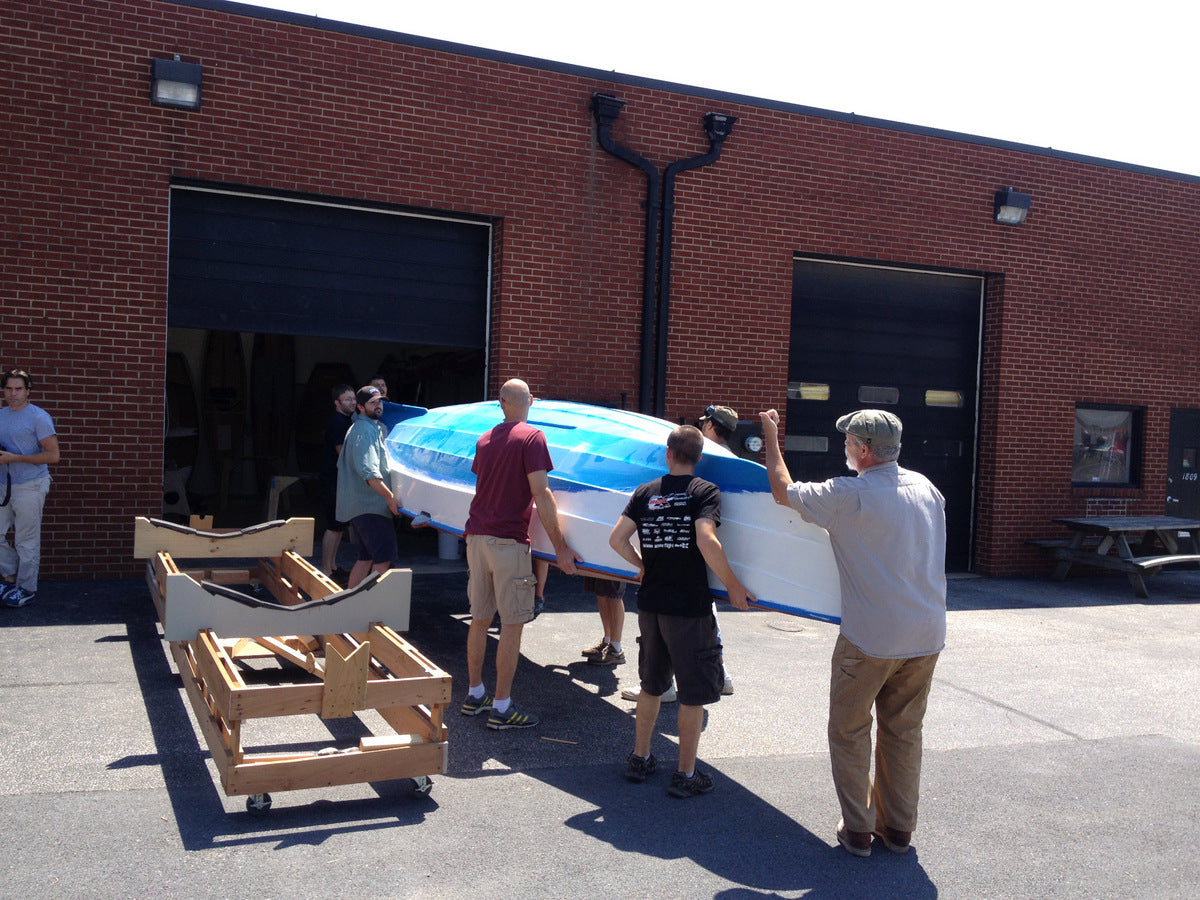 Crew at CLC moving the Faering Cruiser from shop to trailer. 