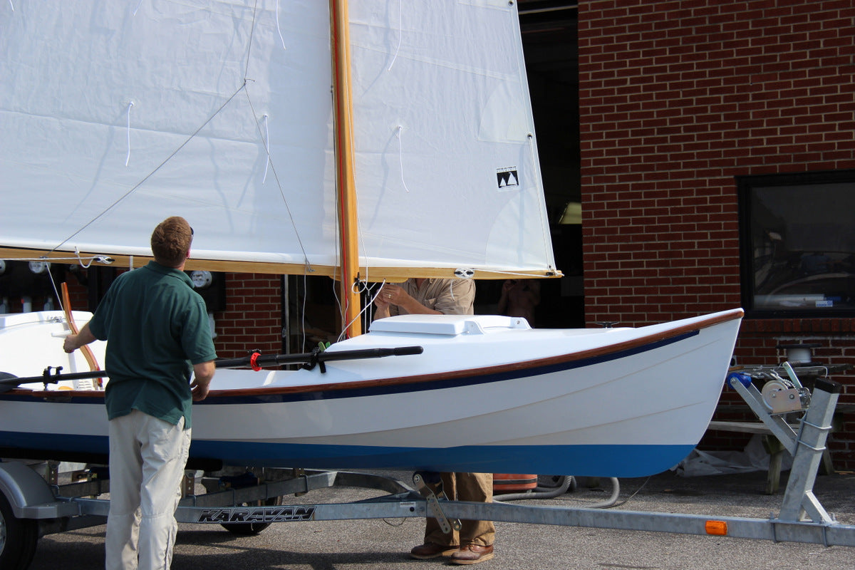 The CLC staff checks the rigging of the new Faering Cruiser prior to launching it.
