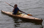 A woman paddling a Great Auk 17 sea kayak by Tom S. Thumbnail