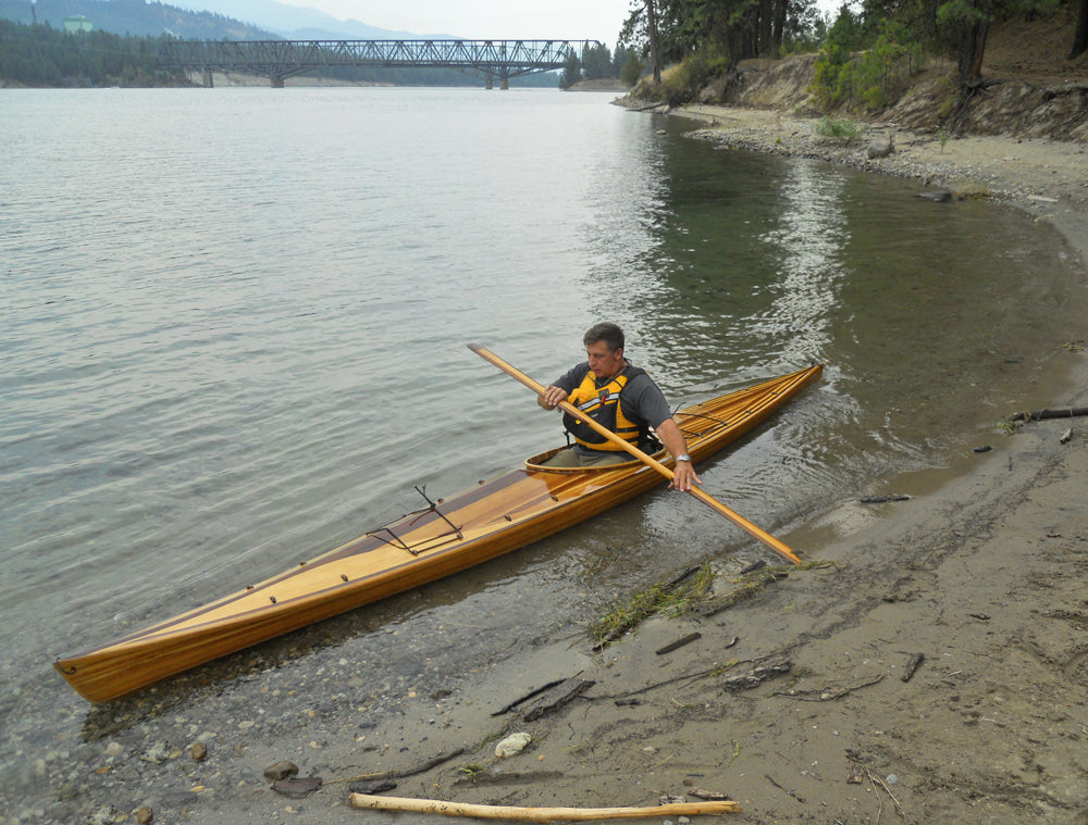 A handsome Great Auk 17 sea kayak built by Alfred C., paddled along a beach
