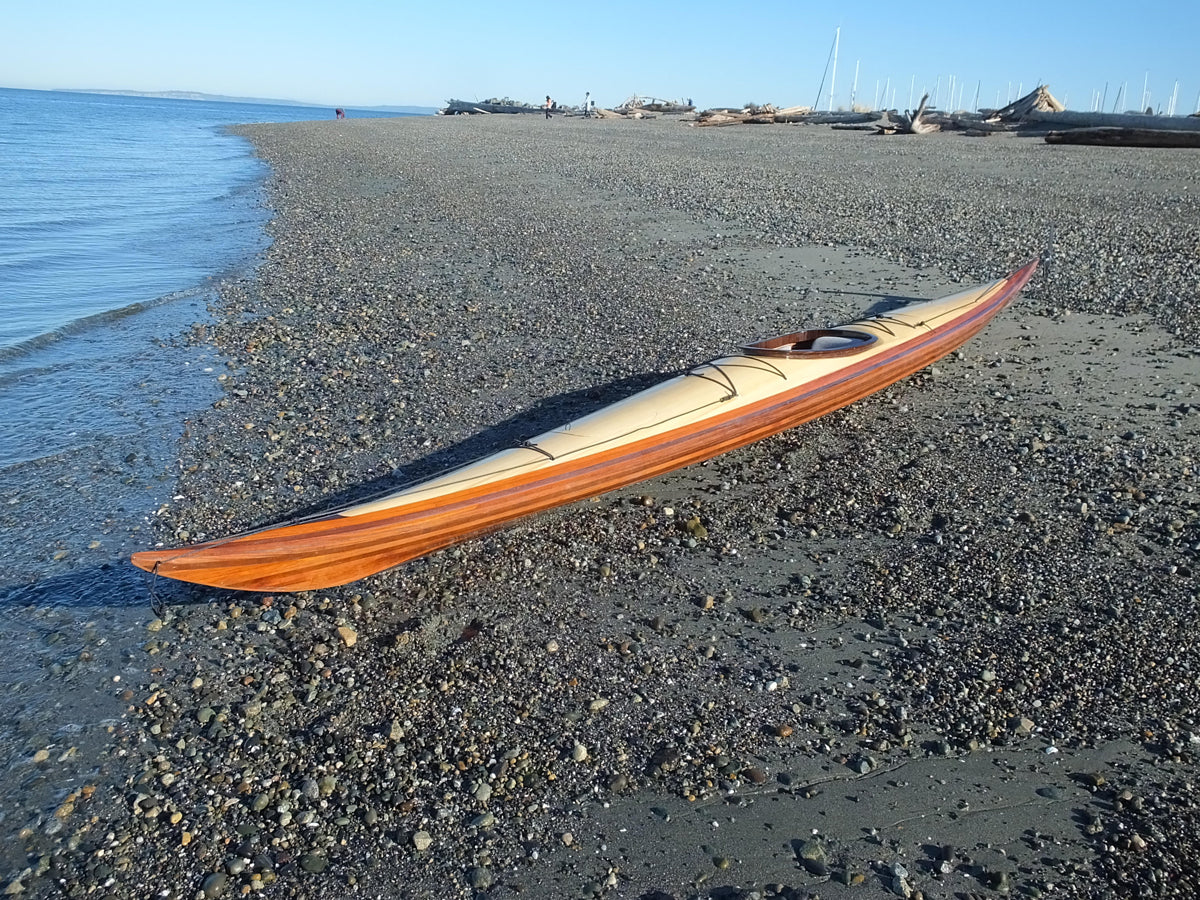 An Expedition Single wooden kayak on the beach