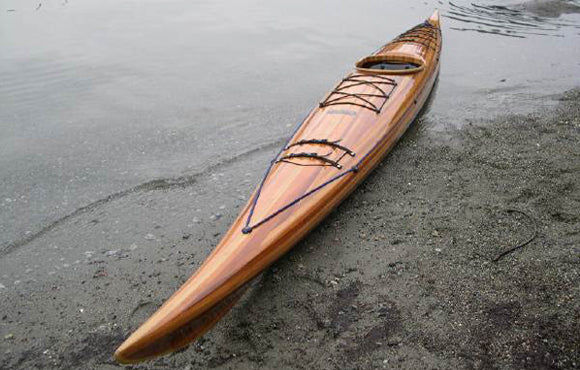 A beached Expedition Single wooden kayak built y Geoff M.