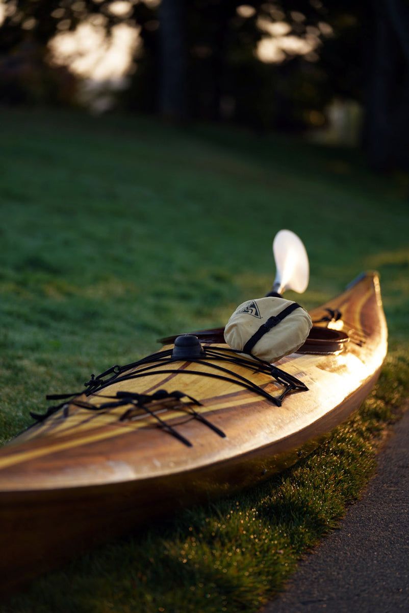 John W's Guillemot Single wooden kayak on the grass