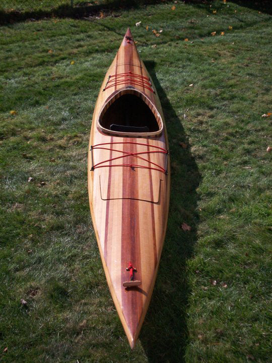 A Guillemot Single wooden kayak build by Ryan M. on the grass