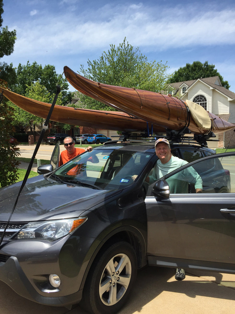 Ready to roll: Dan S. and a friend with Guillemot Single wooden kayak loaded on the cartop