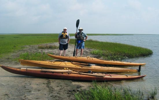 Guillemot and Auk wooden kayaks built by Tony O. at the water's edge