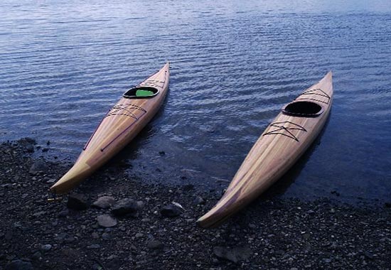 A pair of Guillemot wooden kayaks built by Roy J. and Alan H. at the water's edge