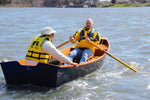 A man rowing with a passenger from the front rowing station of a CLC Jimmy Skiff II. Thumbnail