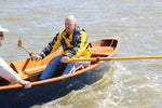 Two men rowing a CLC Jimmy Skiff from the front rowing station.   Thumbnail