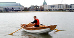 Passagemaker Dinghy rowing in Annapolis Harbor with the US Naval Academy in the background. Thumbnail