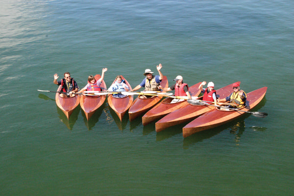 A flock of Wood Duck 10 kayaks launched at the WoodenBoat School