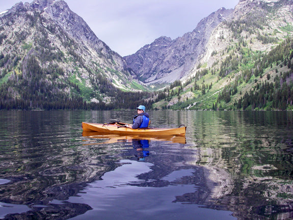 Cheryl J. paddling her Wood Duck 10 kayak on a lake in the Tetons