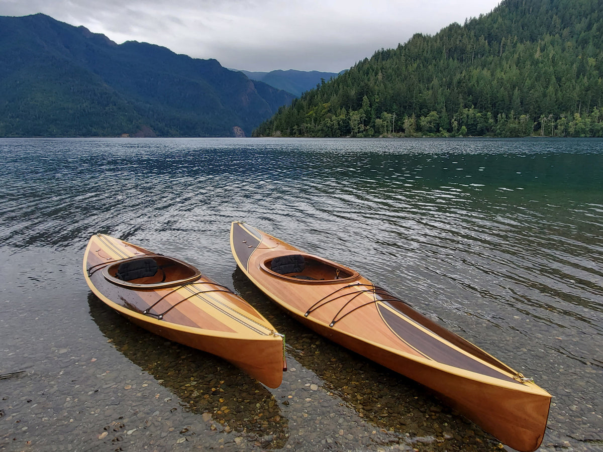 Wood Duck 10 Hybrid and Wood Duck 12 Hybrid kayaks built by Scott S. on the shore of a lake in Washington's Olympic National Park