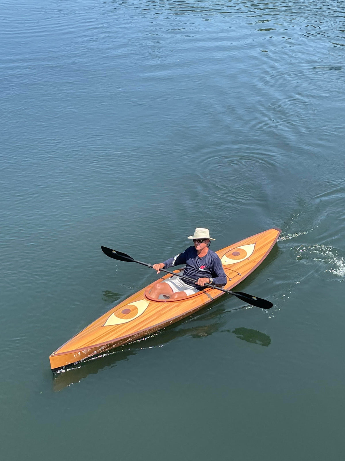 A man paddling a Wood Duck 12 Hybrid kayak built by Brad and Coilin B.