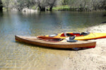 This Wood Duck 14 Hybrid kayak stands out next to its yellow neighbor on the water's edge Thumbnail