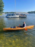 A woman paddling a Wood Duck 14 Hybrid kayak on Lake George in Indiana. Built by Mark G. Thumbnail