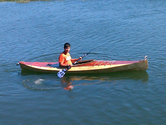 A young paddler in a Wood Duck 14 kayak built by Manuel V.