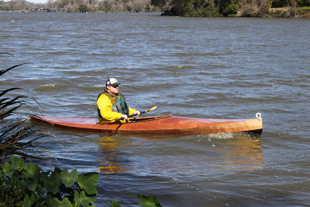A man paddling a Wood Duck 14 kayak built by Bryan P.