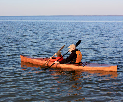 A man and his son paddling a Wood Duck 14 kayak