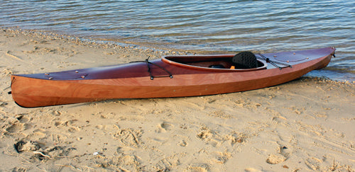 A Wood Duck 14 kayak at the water's edge
