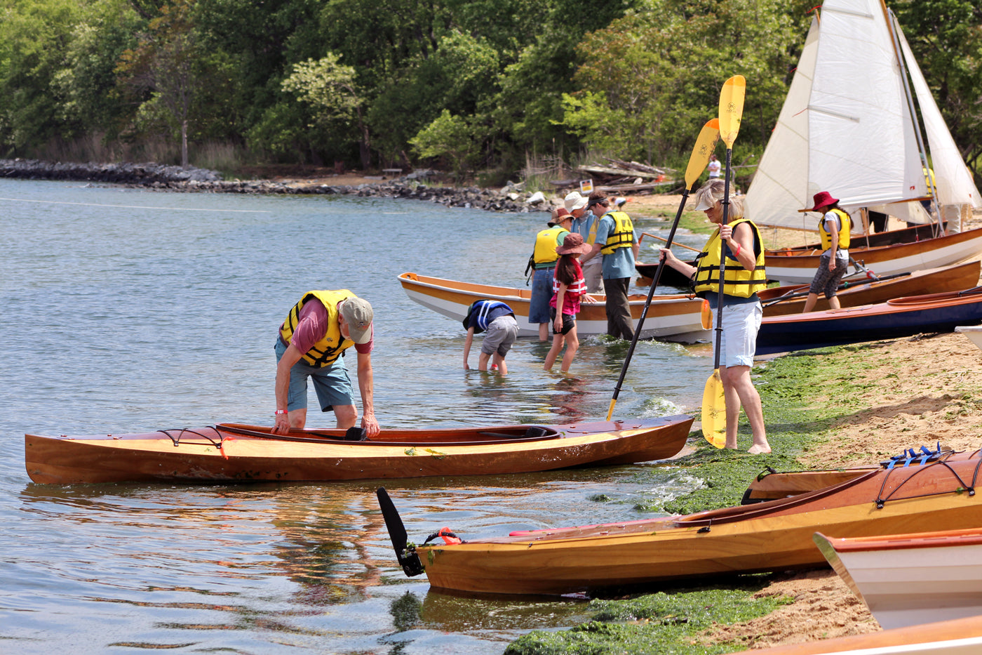 Preparing to launch a Wood Duck Double kayak off the beach at OkoumeFest