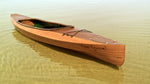 RIVER SQUIRREL, a Wood Duck Double kayak built by Travis H., waits in the shallows on Green Lake in Michigan. Thumbnail