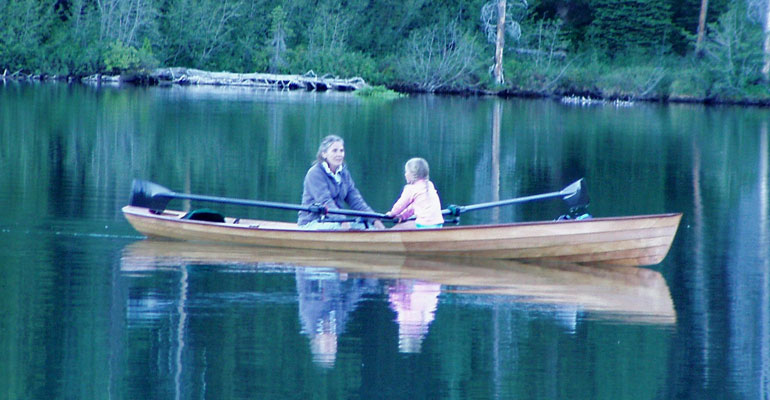 A young girl rowing a passenger in an Annapolis Wherry