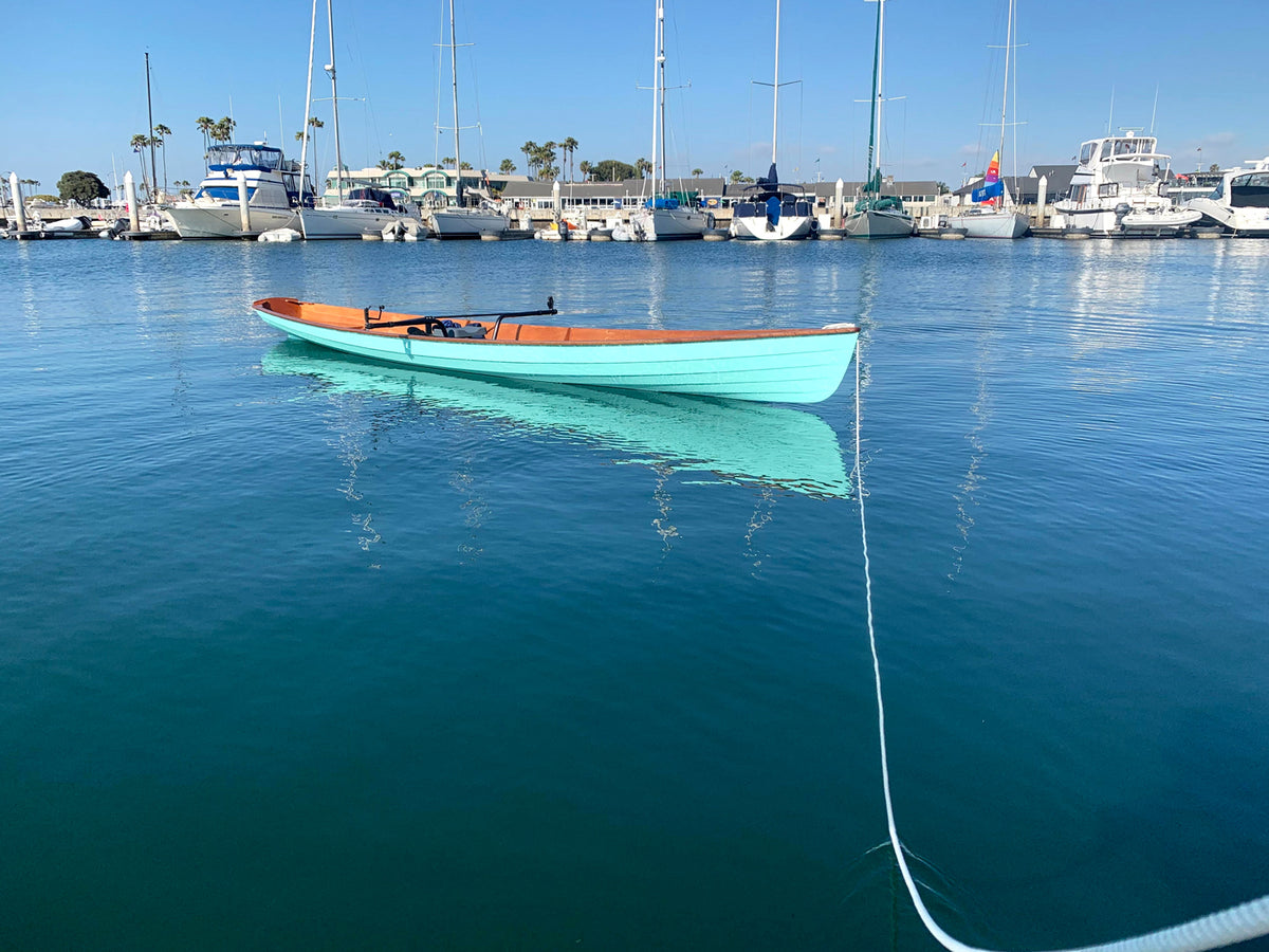 An Annapolis Wherry built by Chris M. floating on the water at Long Beach, Cal.