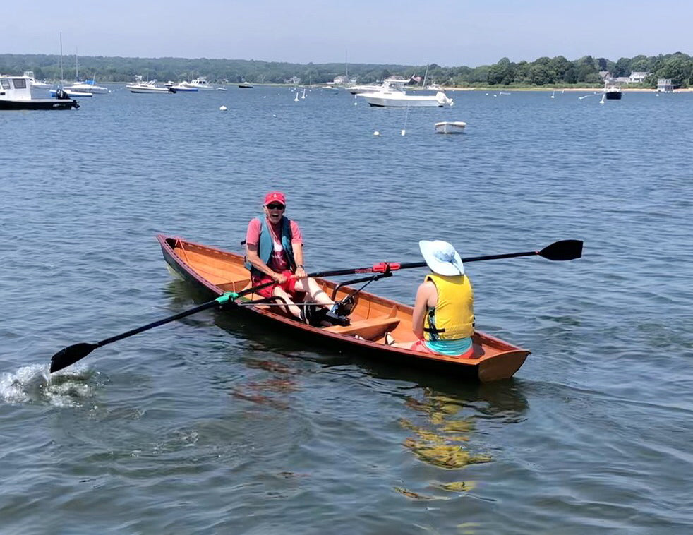 Don and Maddie C. rowing their Annapolis Wherry, built by his grandfather/