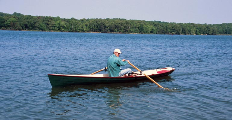 Rowing an Annapolis Wherry on a wooded lake