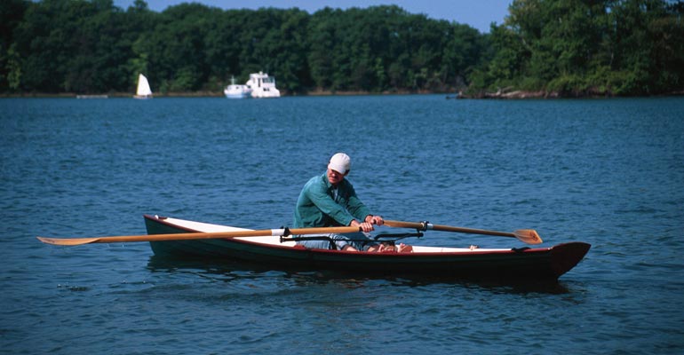Rowing an Annapolis Wherry with a white interior and dark hull