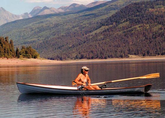 Man rowing an Annapolis Wherry on a mountain lake