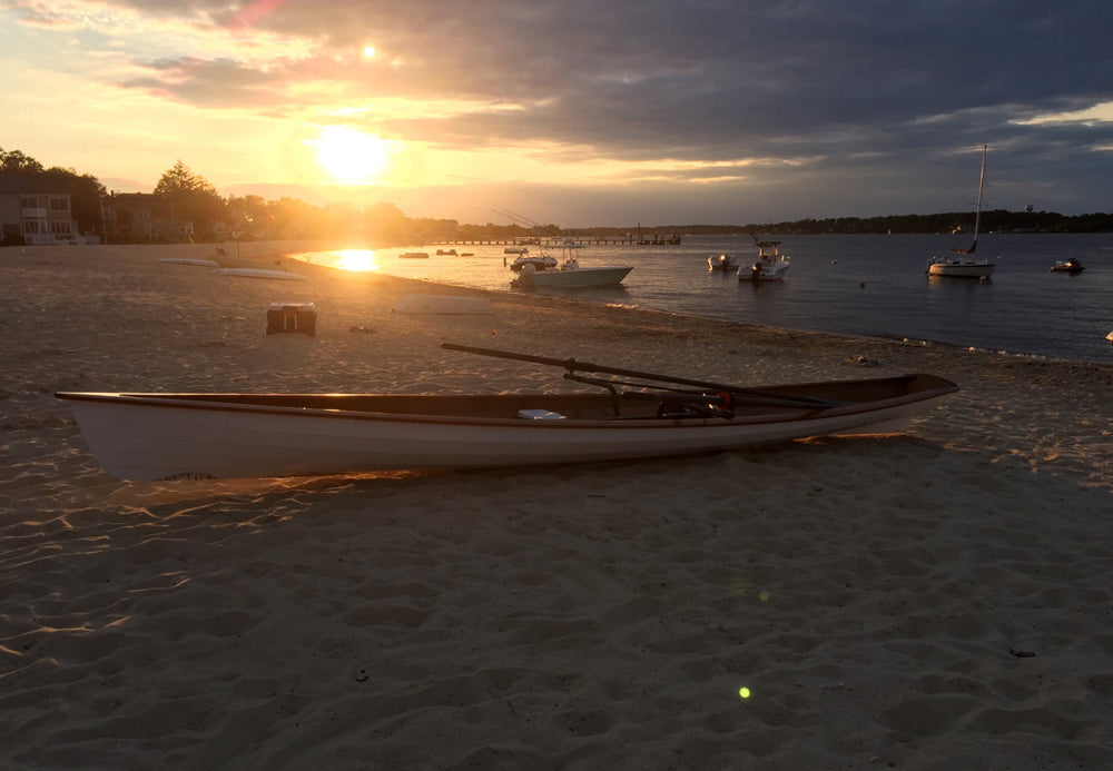 An Annapolis Wherry built by Robert T., on a beach at sunset