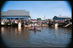 The crowd on the beach and docks at a CLC Family Boatbuilding event, launching multiple Bevin's Skiffs Thumbnail