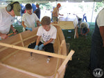 A young builder at work on a Bevin's Skiff wooden boat kit at a Family Boatbuilding event Thumbnail