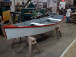 A completed Bevin's Skiff on sawhorses in a workshop Thumbnail