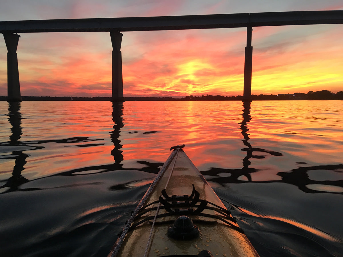 Sunset on the Patuxent River over the bow of a Chesapeake 16LT wooden kayak built by Donald P.