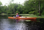 A woman paddling a Chesapeake 16LT wooden kayak built in a class by Mark A. at Mill Pond, NC Thumbnail