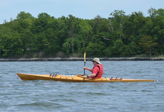 A man paddling a Chesapeake 16LT wooden kayak at OkoumeFest 2012