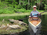 A woman paddling a Chesapeake 16LT wooden kayak built by Mark N. in the Silver River in Central Florida  Thumbnail