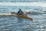 A woman enjoying a day on the waves with a Chesapeake 16LT wooden kayak Thumbnail