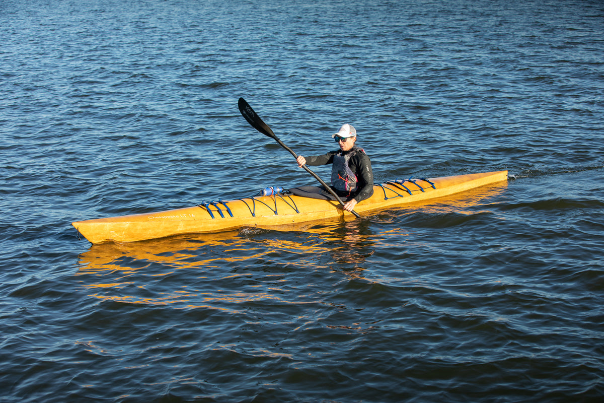 A woman paddling a Chesapeake 16LT wooden kayak