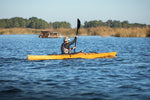 A woman paddling a Chesapeake 16LT toward a marsh Thumbnail